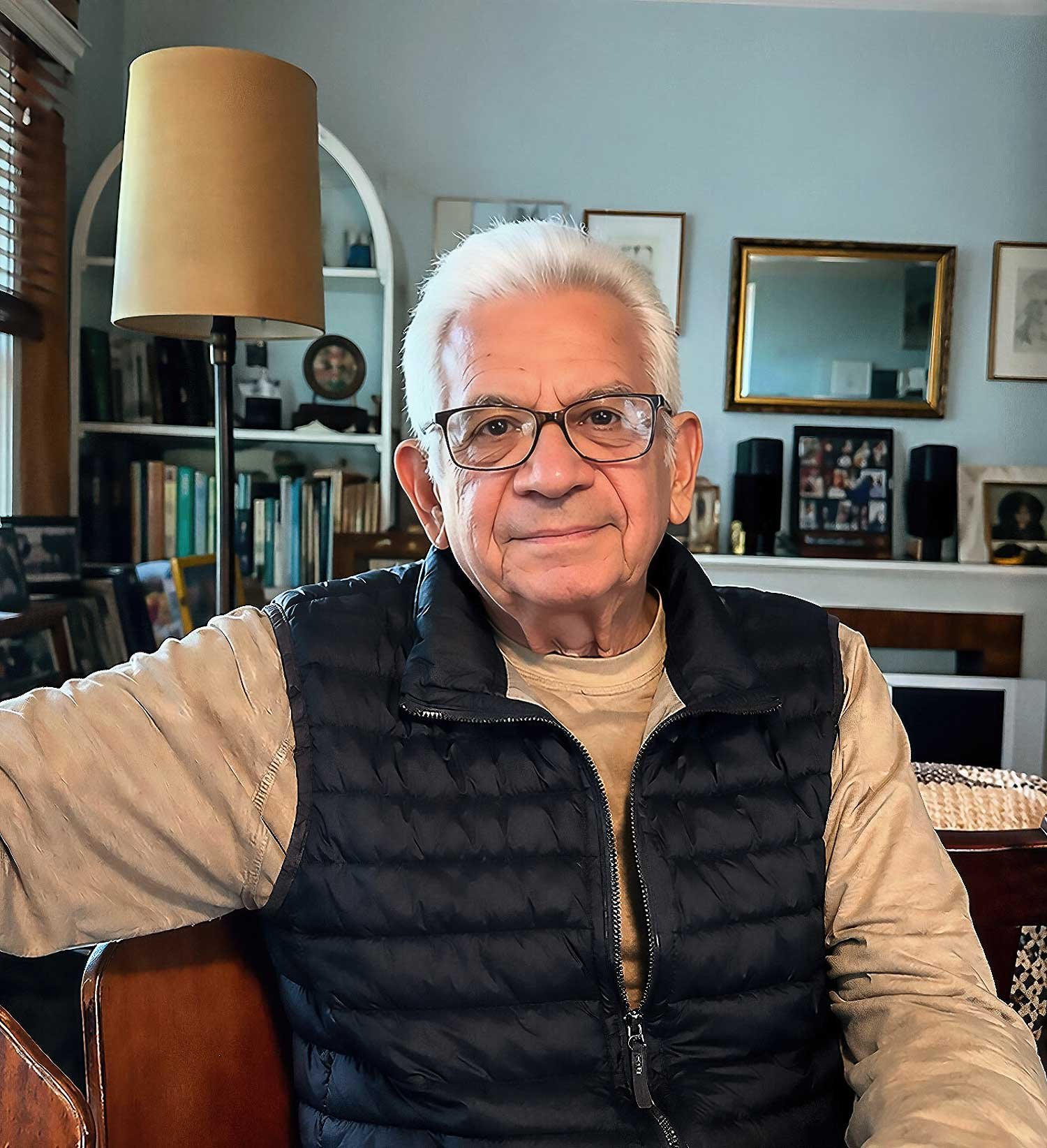 Uncle Bill Lemson, seated at home, wearing a quilted vest, looking calmly toward the camera.