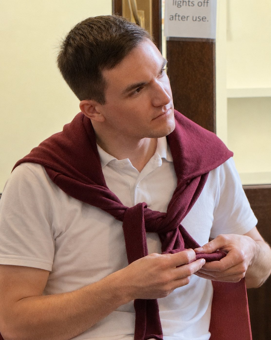 A young man sits in profile, deep in concentration as he listens.