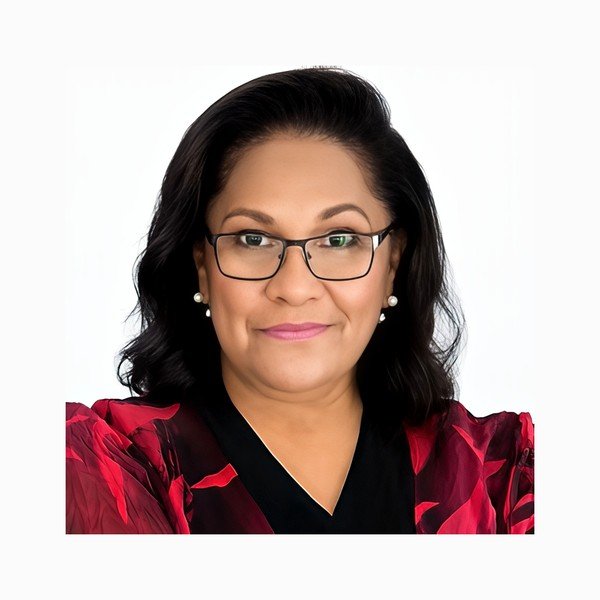Aunty Sandra King OAM, Aboriginal Elder, wearing glasses and a black blouse with red floral pattern.