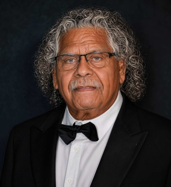 Portrait of Uncle Billy Gorham, Aboriginal Elder, with grey curling hair and glasses.